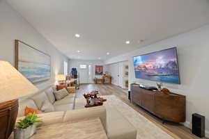 Living room featuring light wood-style floors and recessed lighting