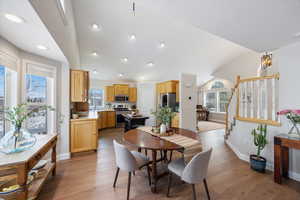 Dining space featuring light wood-style flooring and lofted ceiling
