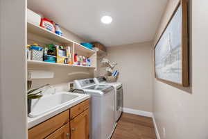 Laundry area featuring dark wood-style flooring and washing machine and clothes dryer