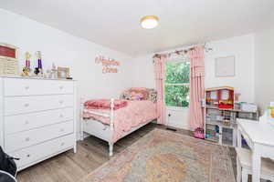 Bedroom with light wood-type flooring and baseboards