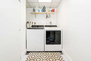 Laundry area featuring a drop ceiling and washer and dryer