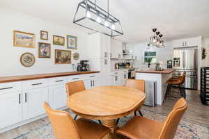 Dining room featuring light wood finished floors and ornamental molding