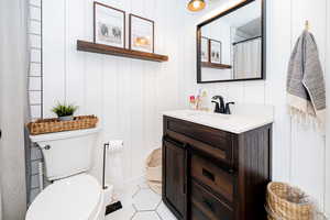 Full bathroom with a shower with shower curtain, vanity, and light tile patterned flooring
