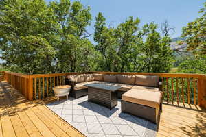 Wooden terrace with an outdoor living space with a fire pit