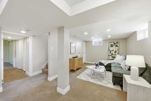 Living area featuring light carpet and recessed lighting