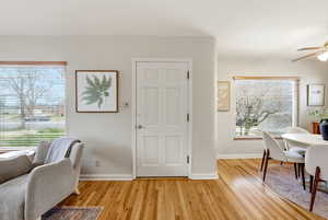 Foyer featuring a ceiling fan and light wood-type flooring