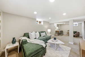 Living area with carpet floors and recessed lighting