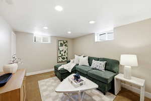 Living area featuring light colored carpet and recessed lighting