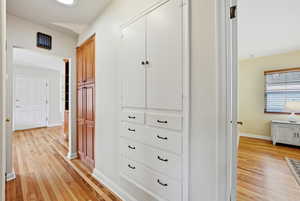 Corridor with light wood finished floors