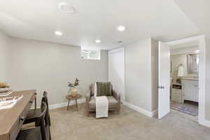 Sitting room featuring light carpet, recessed lighting, and an office area