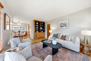 Living area featuring wood finished floors and ceiling fan