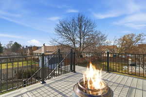 View of patio featuring an outdoor fire pit and a residential view