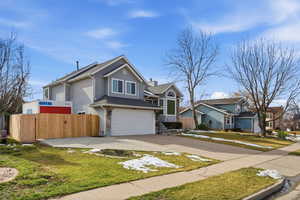 View of front facade featuring driveway and a garage