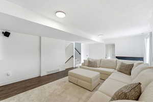 Living area with wood finished floors and a textured ceiling
