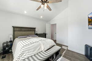 Bedroom with dark wood-type flooring, lofted ceiling, a ceiling fan, and recessed lighting