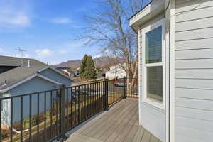 Wooden terrace featuring a mountain view and a residential view