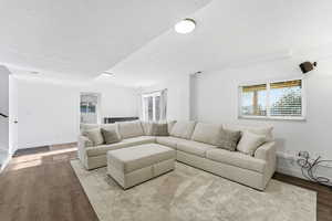Living area with wood finished floors and a textured ceiling