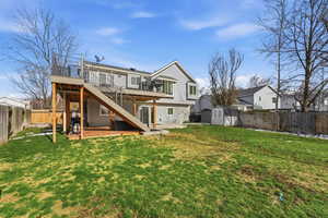 Rear view of house with a deck, a fenced backyard, and a shed