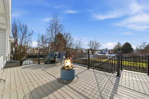 Wooden deck featuring a residential view and a fire pit
