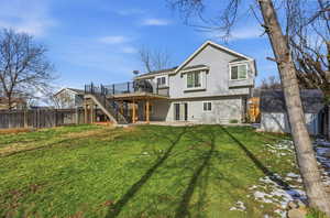 Rear view of property with a patio, a wooden deck, a shed, and a fenced backyard