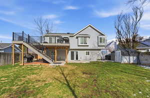 Back of house featuring a patio area, a fenced backyard, a storage unit, and a wooden deck