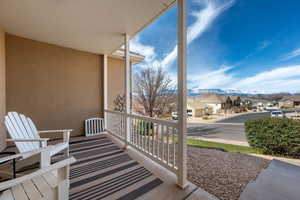 Covered porch featuring a residential view and a mountain view