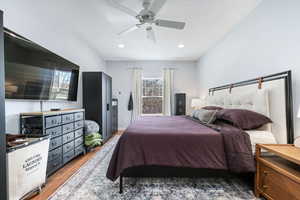 Bedroom featuring wood finished floors and ceiling fan