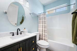 Full bath with vanity and shower / tub combo with curtain
