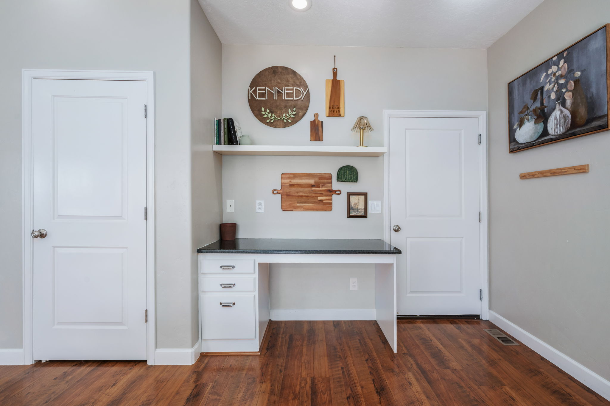Unfurnished office with built in study area and dark wood-style flooring