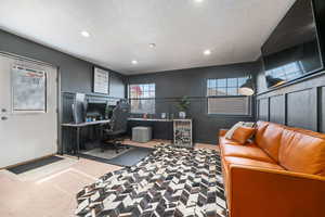 Office featuring recessed lighting, a textured ceiling, and a decorative wall
