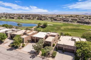Aerial perspective of suburban area featuring a golf course and a water and mountain view