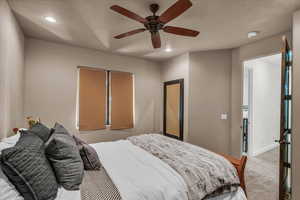 Carpeted bedroom featuring recessed lighting and ceiling fan