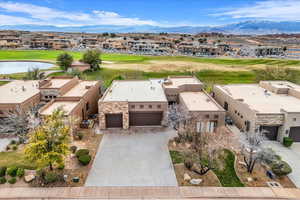 Aerial view of residential area featuring a golf course and a water and mountain view