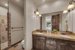 Full bathroom with double vanity, a stall shower, recessed lighting, and light tile patterned floors