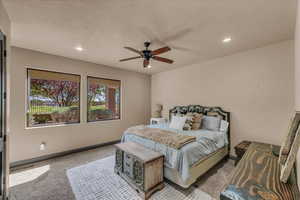 Bedroom featuring light carpet, a ceiling fan, and recessed lighting