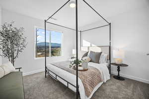 Carpeted bedroom featuring a mountain view and baseboards