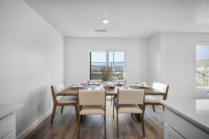 Dining area with dark wood finished floors and baseboards