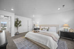 Bedroom with dark carpet and recessed lighting