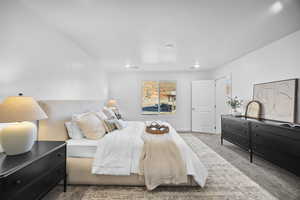 Bedroom featuring carpet and baseboards