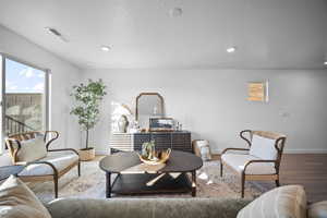 Living area with wood finished floors and baseboards