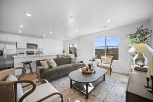 Living room featuring light wood finished floors and recessed lighting