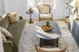 Living area featuring baseboards and light wood-type flooring