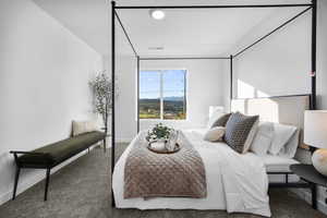 Carpeted bedroom featuring a mountain view and baseboards