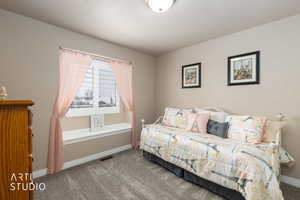 Carpeted bedroom with baseboards
