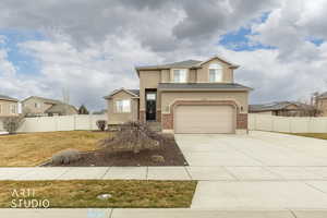 Front of property showing entrance, garage, driveway, and front yard.