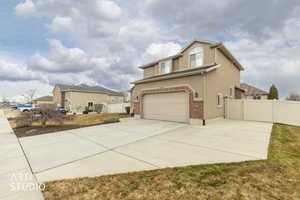 Northwest corner of home showing driveway , RV Storage and side yard entrance.