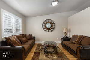Living room with wood flooring and lofted ceiling