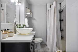 Bathroom featuring vanity and shower / bath combo with shower curtain