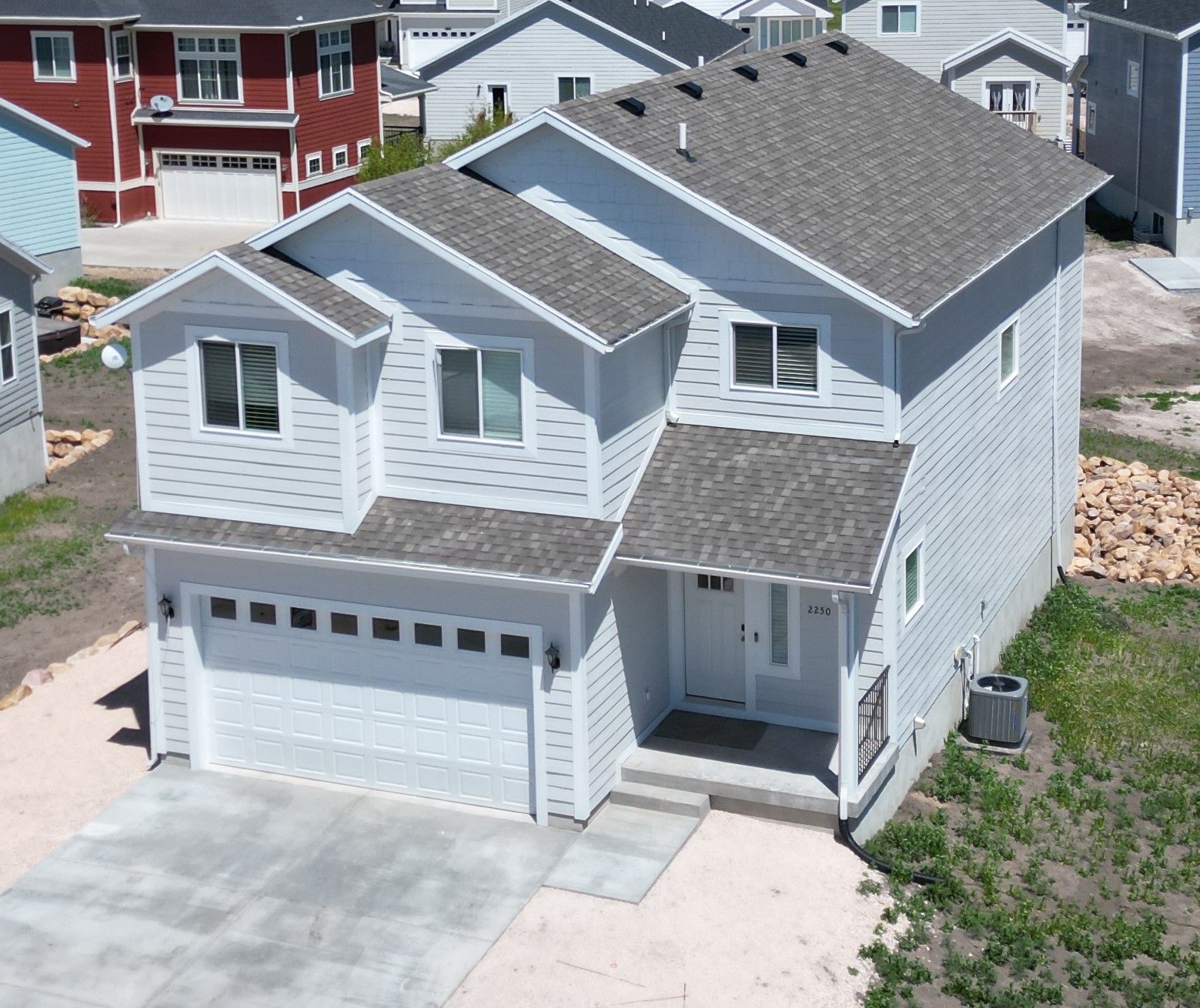 View of front of house featuring a shingled roof, a garage, and concrete driveway