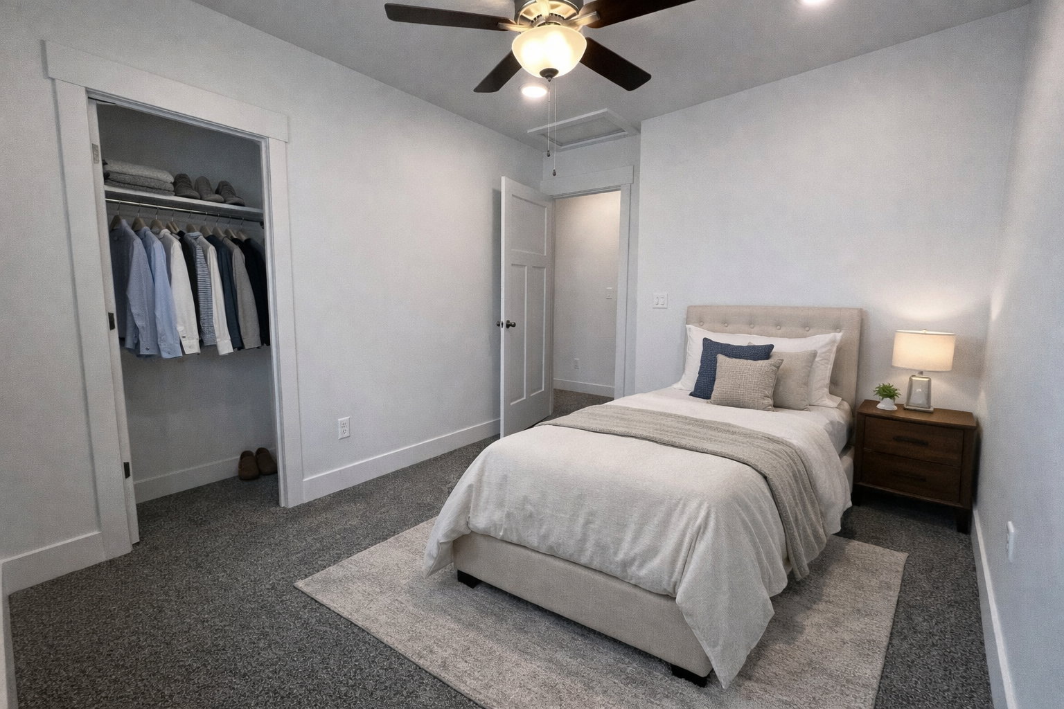 Bedroom with carpet flooring, a ceiling fan, and a closet